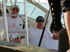 The crew of the Martuni looks on with disappointment as its disqualified bigeye -- bitten by a mako -- is weighed.